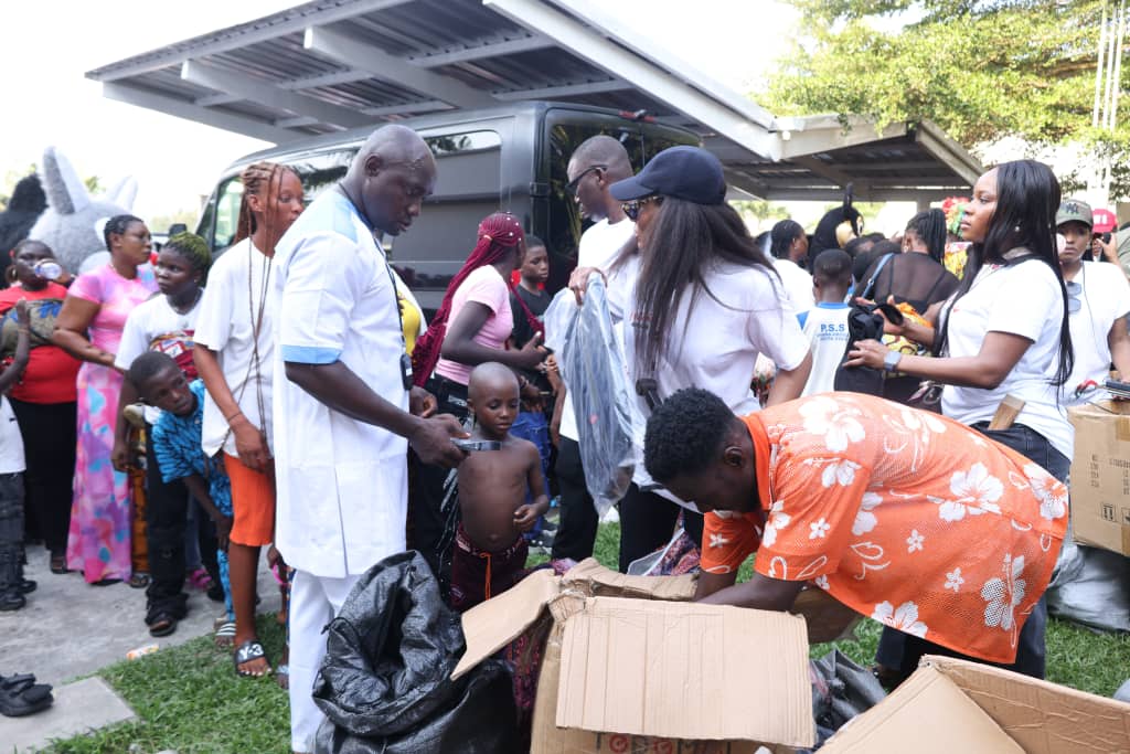 Gifts and clothing being distributed to children